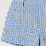 Blue patterned shorts worn by a person on a plain background