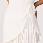 White dress with a pleated skirt and floral detail on a white background
