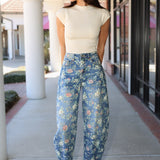 Floral denim barrel jeans and cream ribbed mock neck top