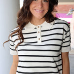 Woman wearing a black and white striped shirt with a blurred background