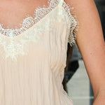 A woman wearing a light beige blush camisole top with white lace trim along the neckline, styled with Highway sunglasses by Z Supply at Rodeo Boutique.