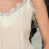 A woman wearing a light beige blush camisole top with white lace trim along the neckline, styled with Highway sunglasses by Z Supply at Rodeo Boutique.