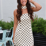 Cream strapless mini dress with black polka dots with matching scarf from Rodeo Boutique.