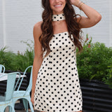 Cream strapless mini dress with black polka dots with matching scarf from Rodeo Boutique.