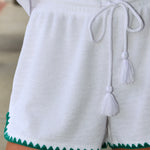 Woman wearing white Coasline Shorts and Miles Top by Z Supply