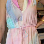 Pastel tie-dye dress worn by a person with a blurred background