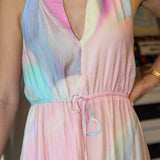 Pastel tie-dye dress worn by a person with a blurred background