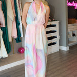 Woman wearing a pastel midi dress in a clothing store.