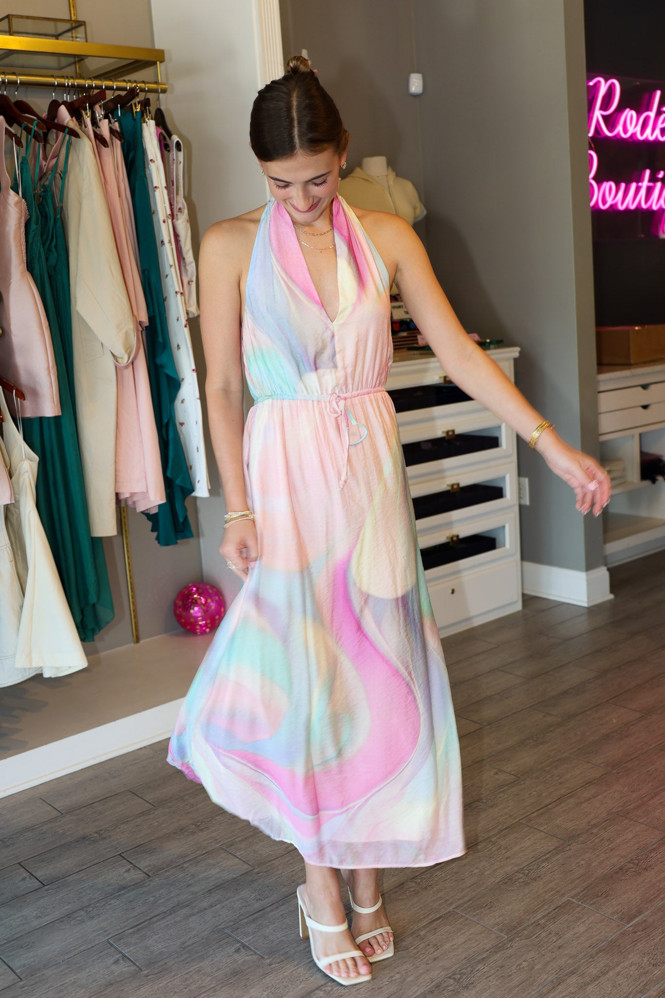 Woman wearing a colorful dress in a clothing store.