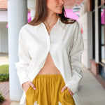 Steve Madden Daisee mustard yellow shorts with lace trim worn by a person.