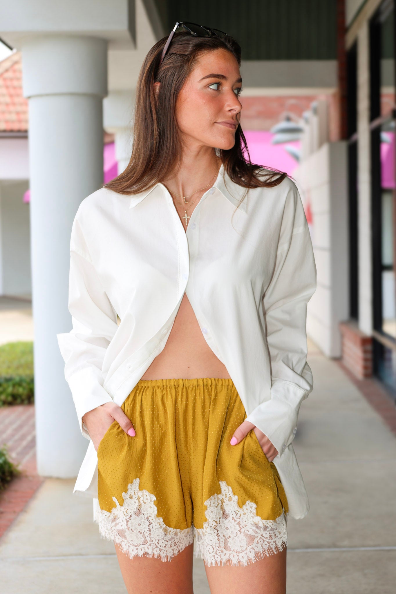 Steve Madden Daisee mustard yellow shorts with lace trim worn by a person.
