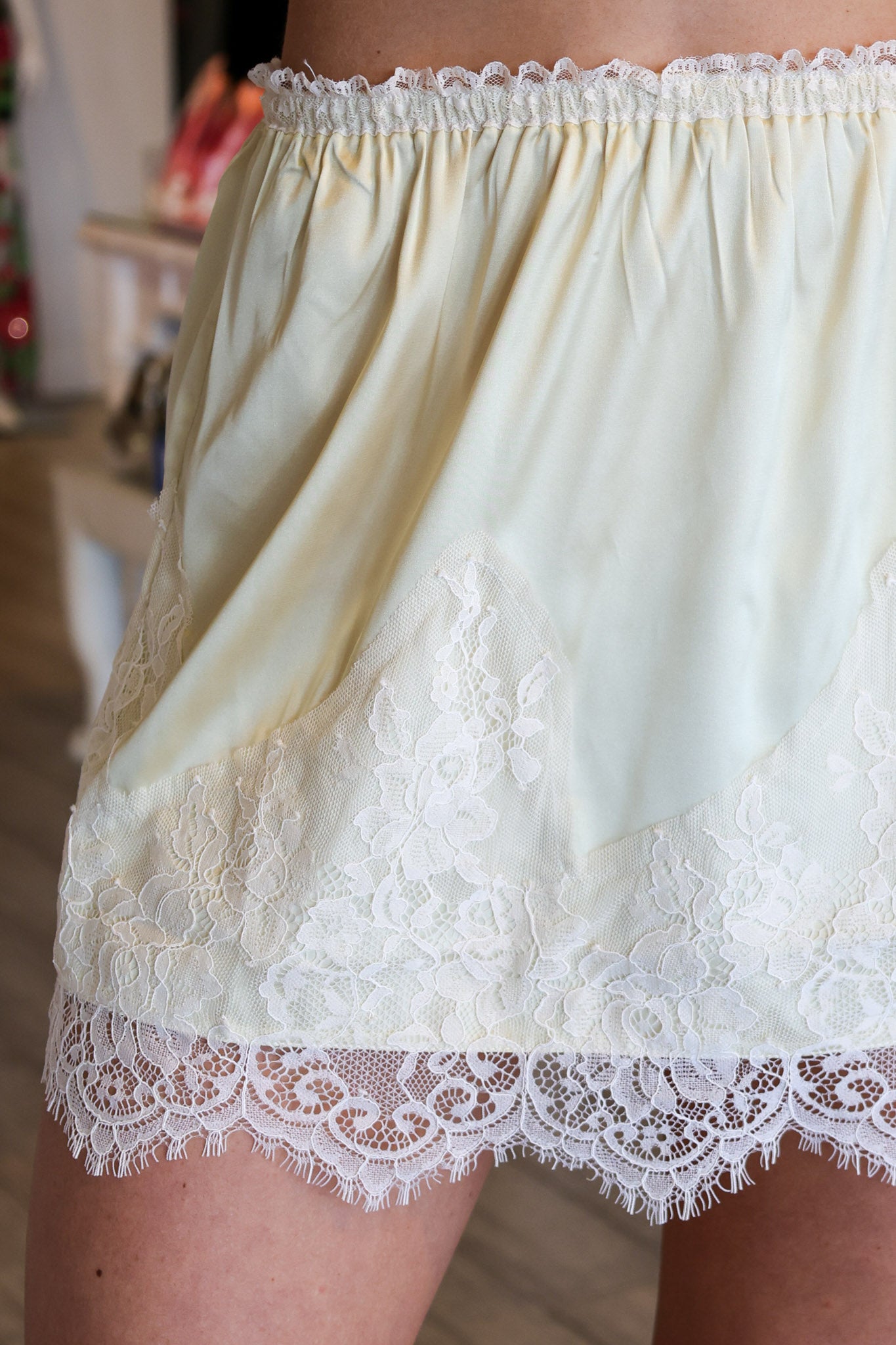 Light-colored lace-trimmed skirt with a blurred background
