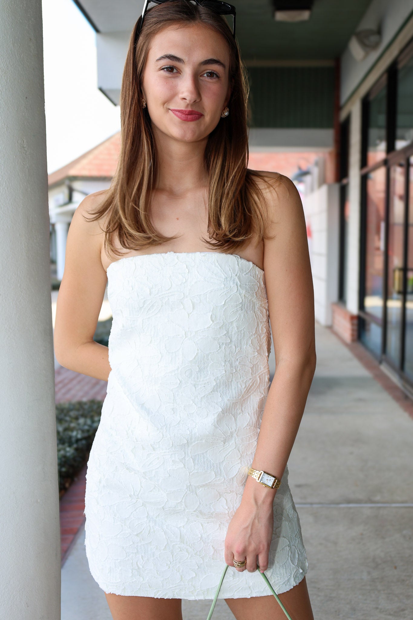 Woman wearing a white strapless dress standing outdoors. Elliatt Edelie Dress