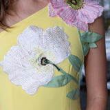 Yellow dress with floral embroidery on a blurred background