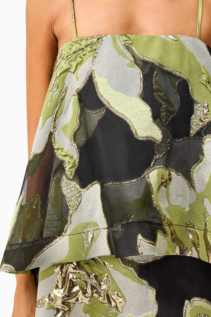 Woman wearing the Elysia dress by Elliatt that is green floral camouflage dress on a white background