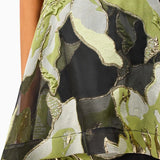 Woman wearing the Elysia dress by Elliatt that is green floral camouflage dress on a white background