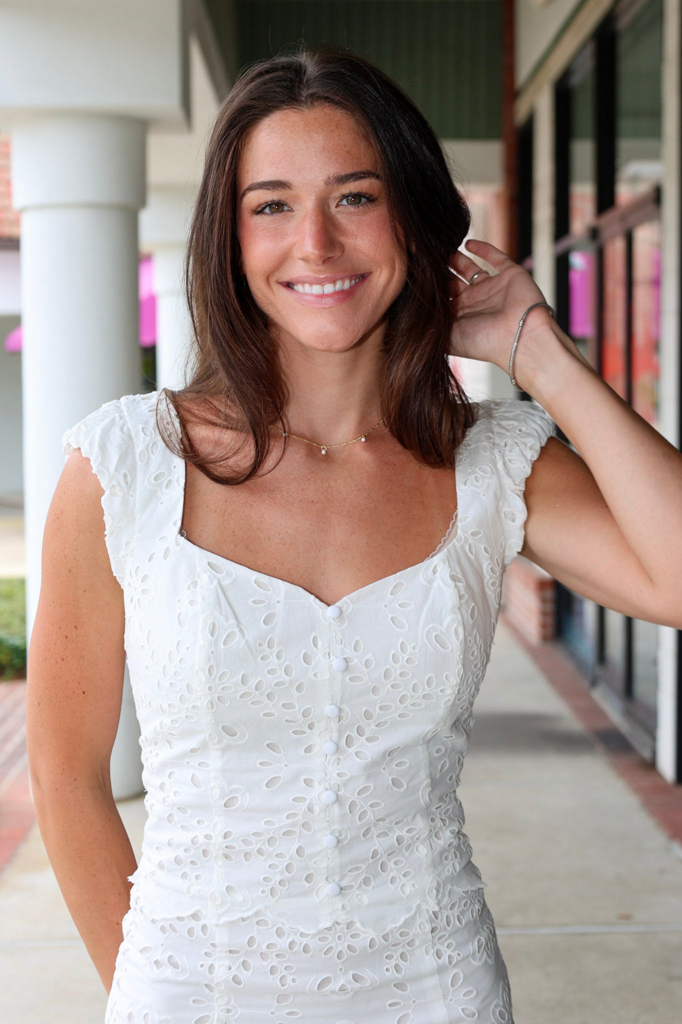 Woman in a white eyelet Emrie Top and matching Emrie skirt.  