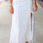 Woman in a white eyelet Emrie Top and matching Emrie skirt.  
