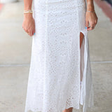 Woman in a white eyelet Emrie Top and matching Emrie skirt.  