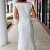 Woman in a white eyelet Emrie Top and matching Emrie skirt.  