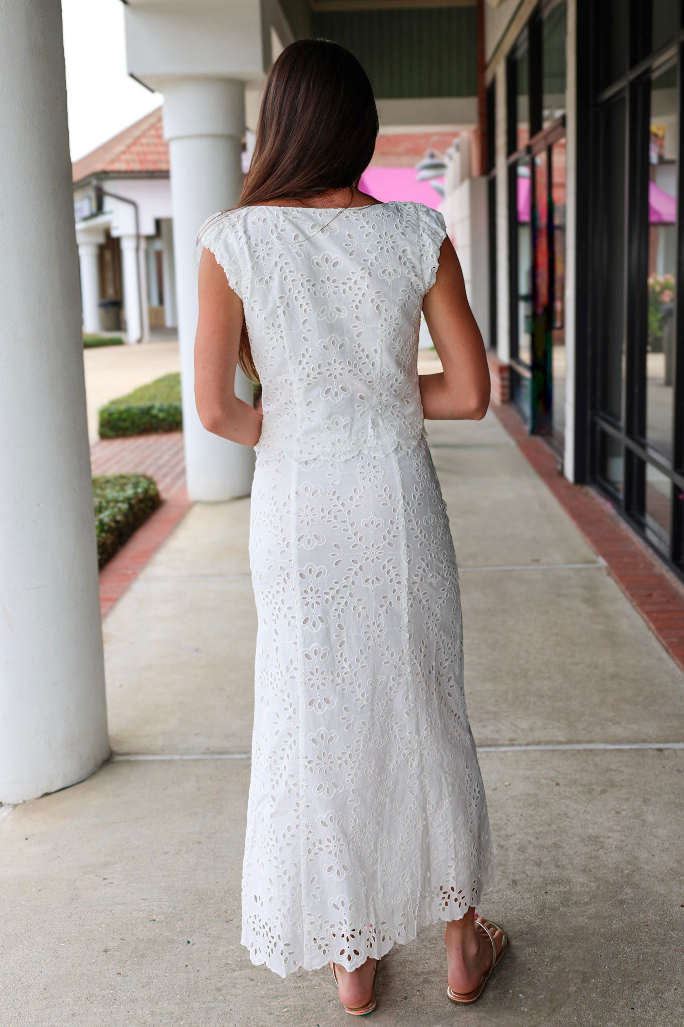 Woman in a white eyelet Emrie Top and matching Emrie skirt.  