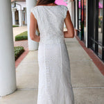 Woman in a white eyelet Emrie Top and matching Emrie skirt.  