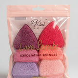 Pack of exfoliating sponges in pink, purple, and red packaging on a white surface.