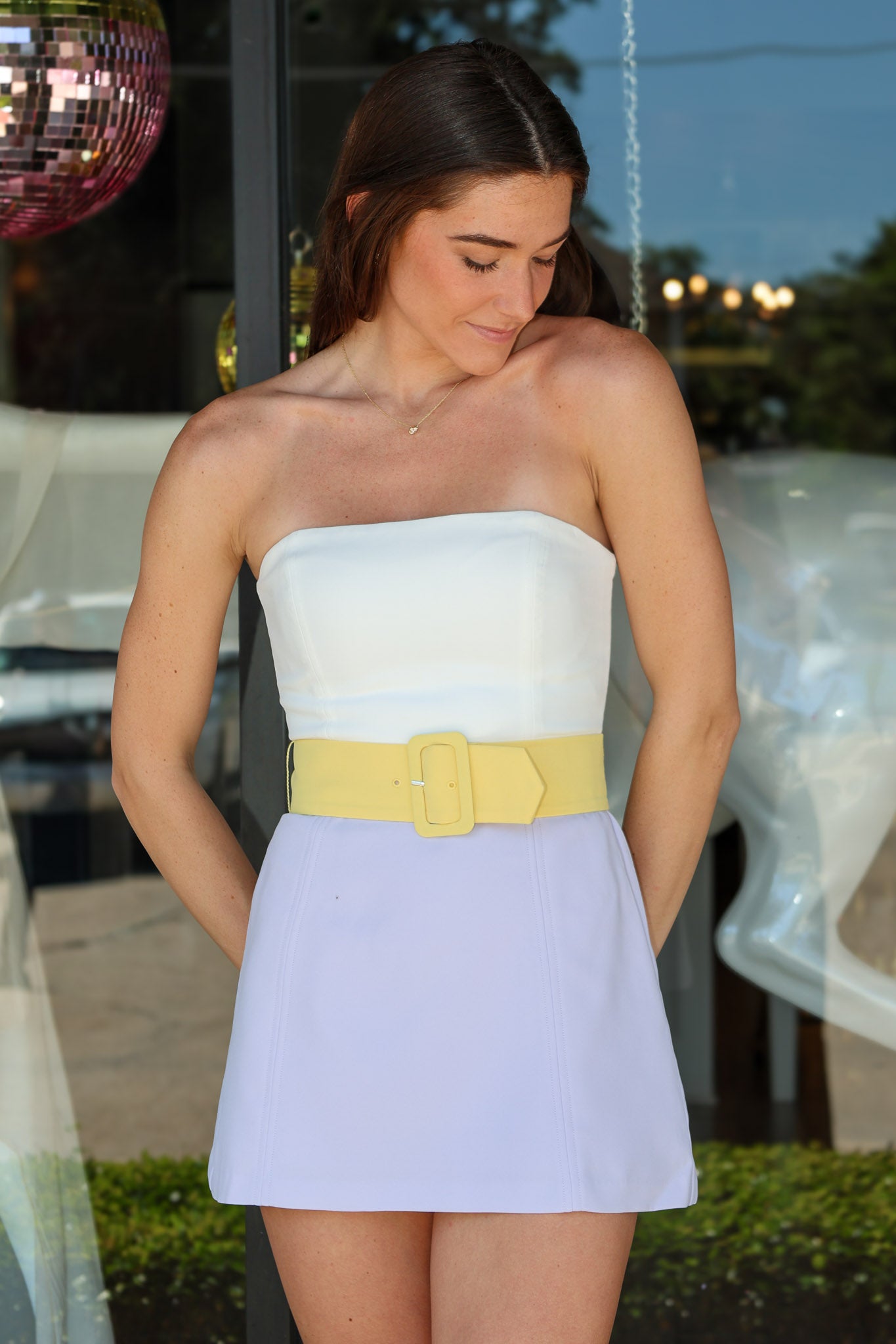 Fae Romper, Amanda Uprichard —a purple yellow strapless color-block mini