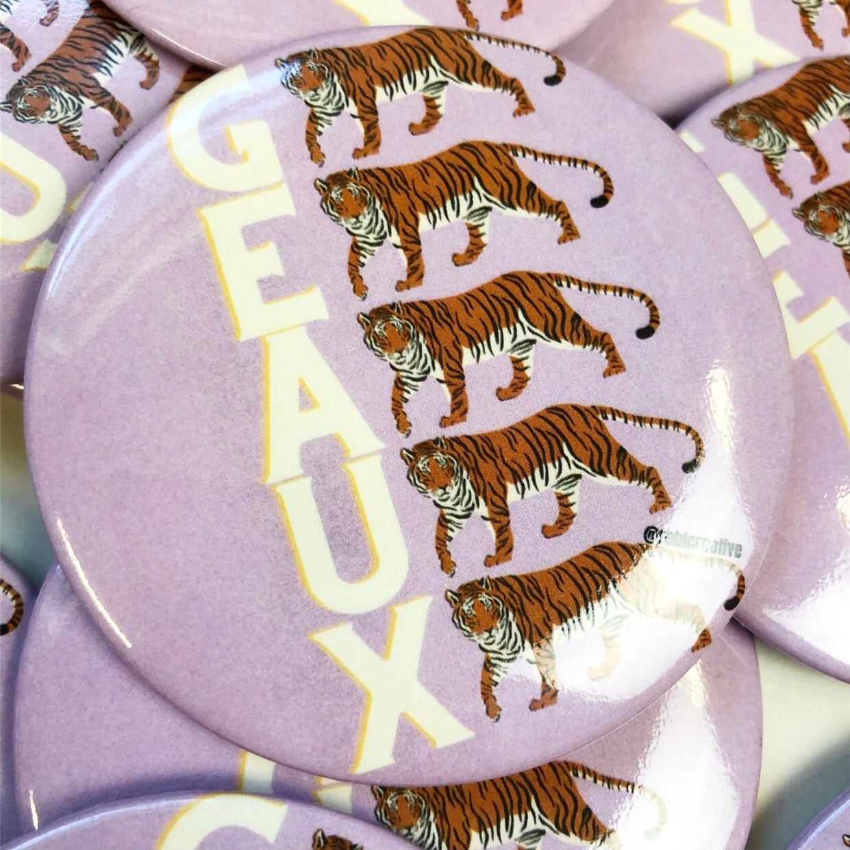 Gameday Button pin with tigers and 'GEaux' text on a purple background