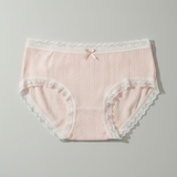 Pink lace-trimmed underwear on a gray background