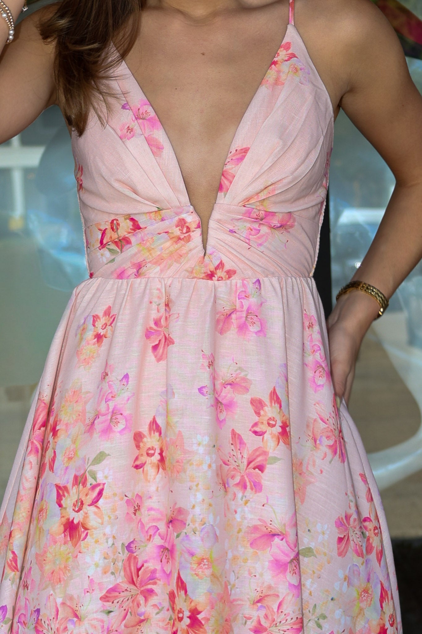 Pink floral dress with a plunging neckline, worn by a person.