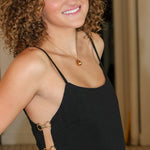 Black sleeveless camisole top with side cutouts and matching black wide-leg pants from Rodeo Boutique.