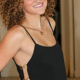 Black sleeveless camisole top with side cutouts and matching black wide-leg pants from Rodeo Boutique.