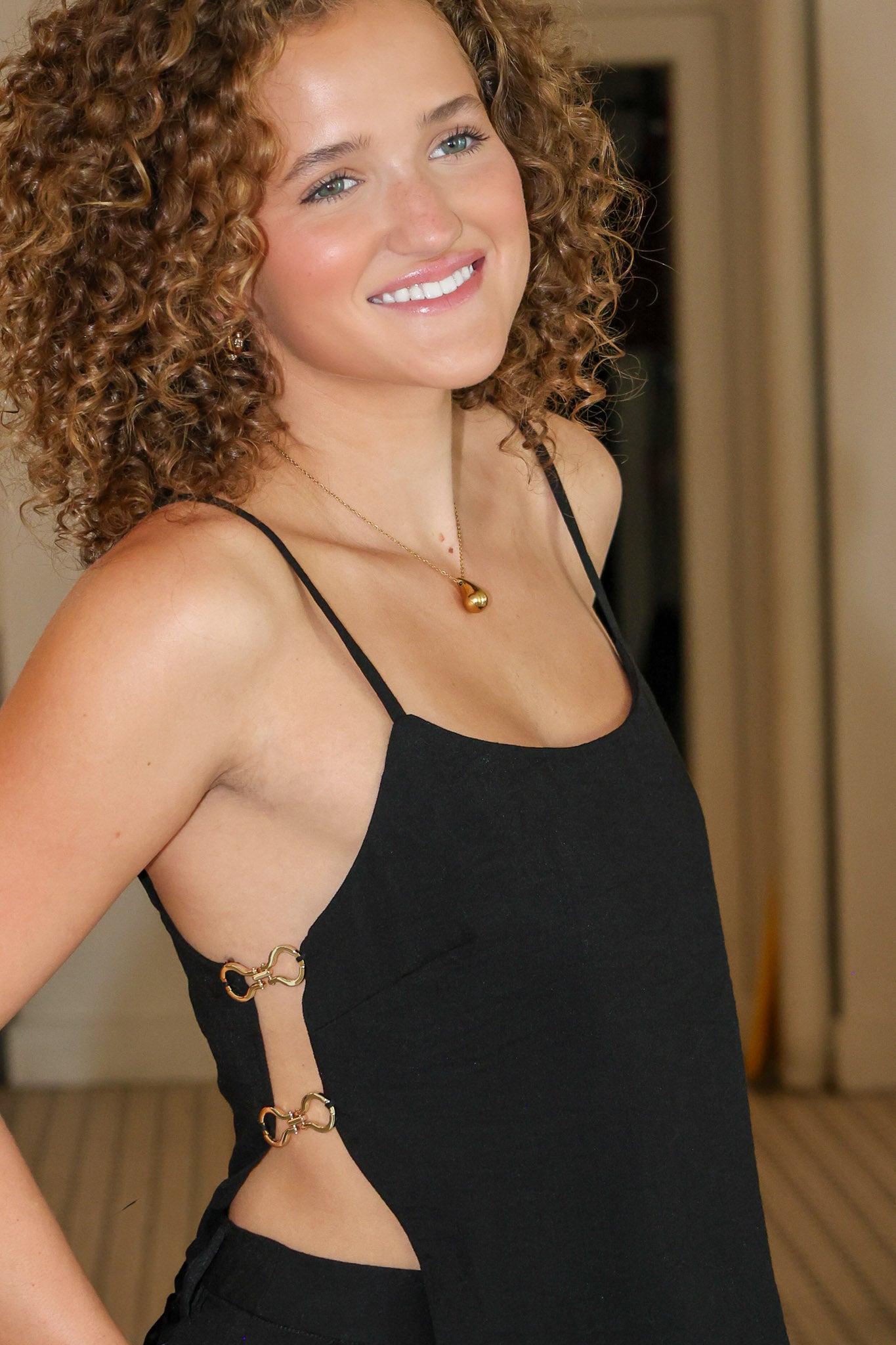Black sleeveless camisole top with side cutouts and matching black wide-leg pants from Rodeo Boutique.
