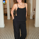 Black sleeveless camisole top with side cutouts and matching black wide-leg pants from Rodeo Boutique.