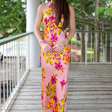 Woman in a floral dress standing on a wooden deck