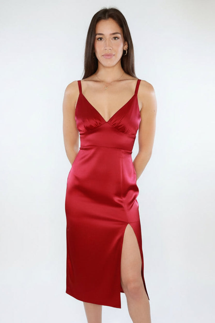 Woman wearing a red satin dress with a white background