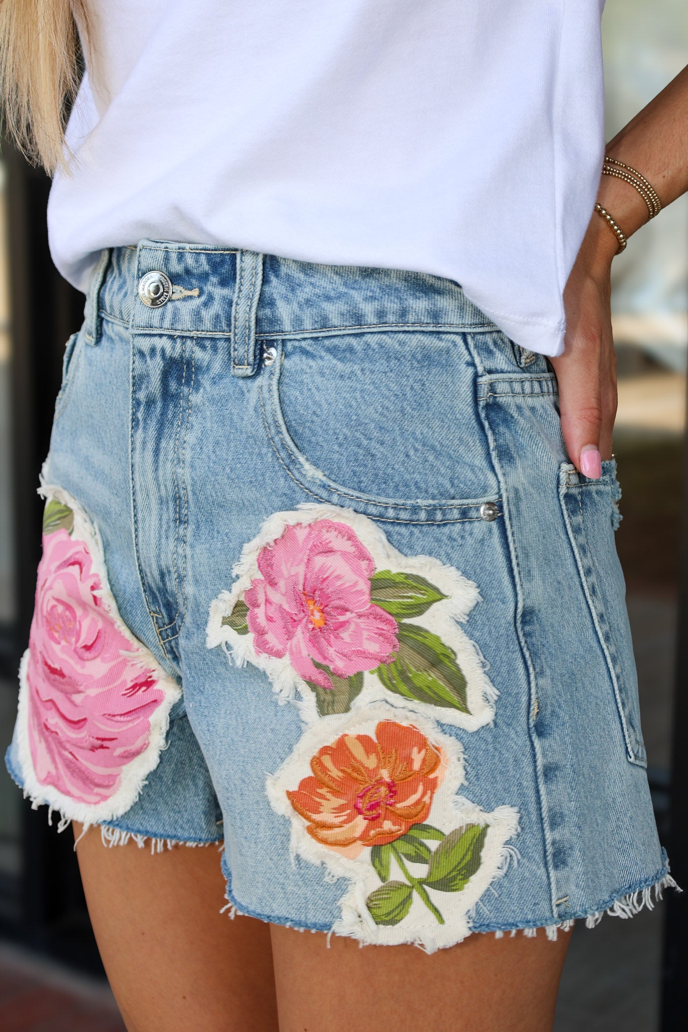 Denim skirt with floral patches worn by a person