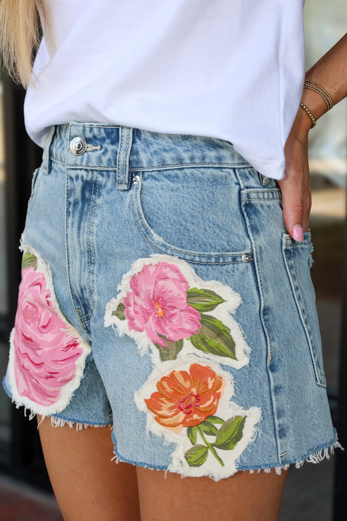 Denim skirt with floral patches worn by a person