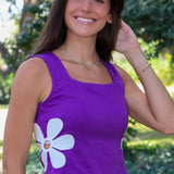 purple tank top with a large white flower graphic on the front, photographed outdoors at Rodeo Boutique.
