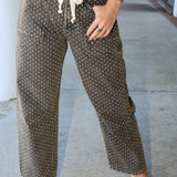 Person wearing polka dot pants with a neutral background