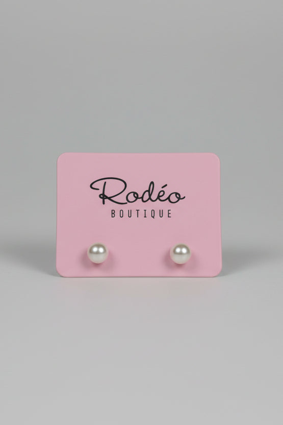 Pink card with 'Rodeo Boutique' text on a light gray surface