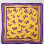 A square satin scarf with a vibrant yellow background, decorated with a pattern of purple butterflies and a matching purple border, shown flat against a white background.
