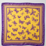 A square satin scarf with a vibrant yellow background, decorated with a pattern of purple butterflies and a matching purple border, shown flat against a white background.