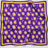 A square purple silk scarf with a yellow and light purple abstract pattern and a yellow border, displayed flat against a white background.