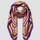 A square silk scarf featuring a geometric pattern of concentric squares in purple and yellow, displayed flat with soft folds on a white background.