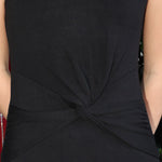 sleeveless black knit midi dress with a knot detail on a person