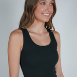 A woman wearing a black ribbed tank top.