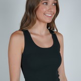 A woman wearing a black ribbed tank top.