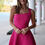 Woman wearing a pink one shoulder mini dress